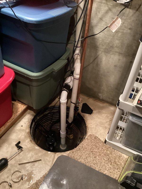 Responded to sump pump service call where customer reported water accumulation in basement. Inspected sump pit system with standing water and found partially submerged pump with compromised check valve assembly. Replaced faulty check valve, cleared debris from pump intake, and verified proper operation with successful water evacuation test.