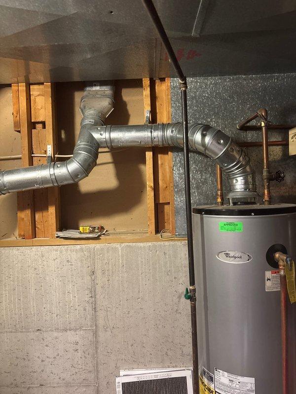 Performed annual furnace tune-up, including inspection of the Whirlpool water heater system with connected copper piping and Y-shaped metal vent configuration. Examined air filter and verified proper ventilation through the ductwork. Customer renewed maintenance agreement for both furnace and AC units.