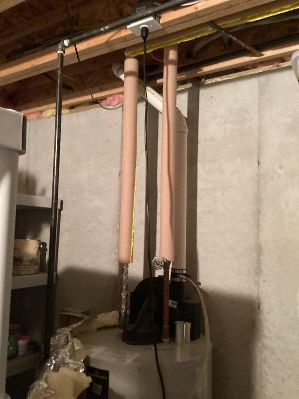 Conducted comprehensive assessment for water heater replacement in 20-year-old home with original water heater showing signs of age. Inspected existing plumbing connections including copper supply lines, gas line, and valve assembly. Documented current installation configuration to ensure proper sizing and compatibility for replacement unit.