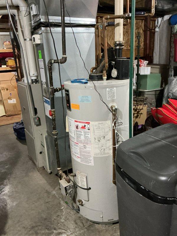 Responded to water softener malfunction complaint (CWOW). Upon inspection, found motor assembly on top of water softener tank showing significant corrosion and deterioration. Diagnosed electrical issue with motor connection, repaired wiring connections and cleaned corrosion from terminals to restore proper operation.