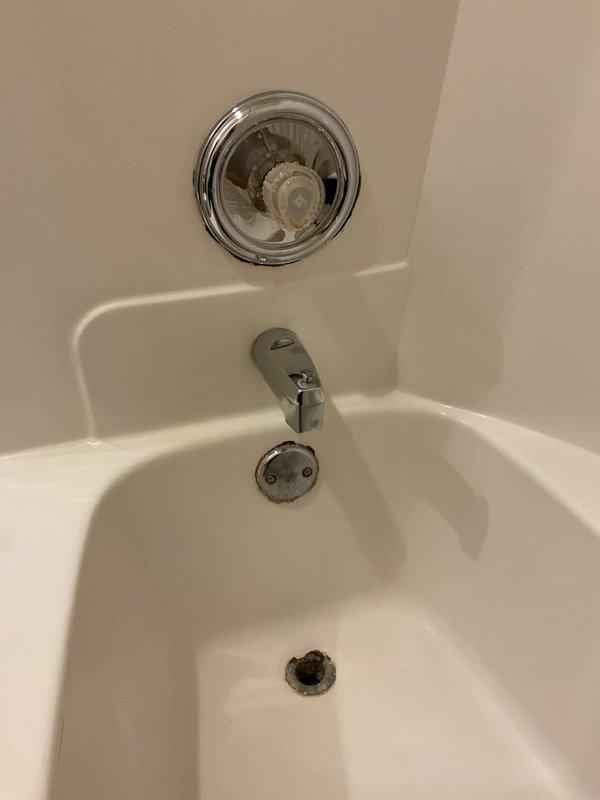 Repaired leaking shower faucet in primary bathroom by replacing worn cartridge assembly and adjusting pressure regulator. Additionally, installed new pop-up drain assemblies in both bathtubs, ensuring proper water retention and drainage functionality.