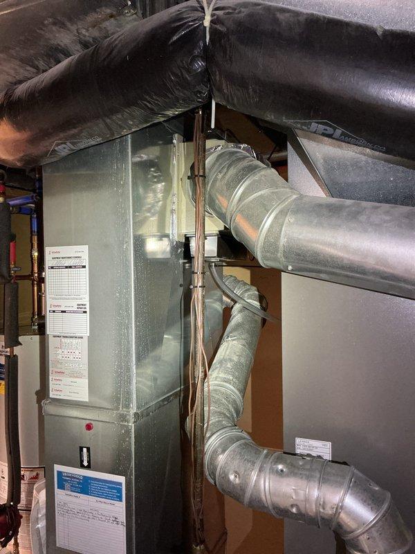 Performed annual furnace tune-up on 4-year-old Lennox system under Choice home warranty. Inspected basement installation including main unit, ductwork, control box, and copper connections. System showing normal wear but functioning properly; no issues identified during comprehensive maintenance service.