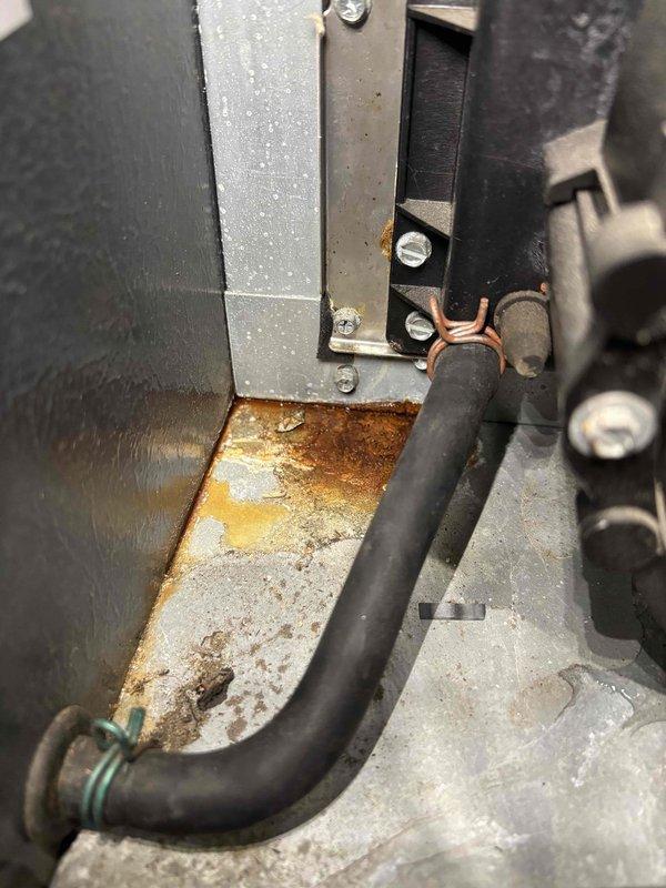 Completed annual heating service on a 15-year-old furnace system without humidifier. Inspection revealed significant rust and corrosion at the base of the equipment and connection points. System is operational but showing expected wear consistent with age.