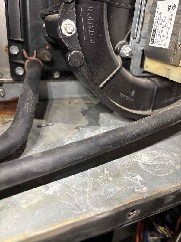 Completed annual heating service on a 15-year-old furnace system without humidifier. Inspection revealed significant rust and corrosion at the base of the equipment and connection points. System is operational but showing expected wear consistent with age.