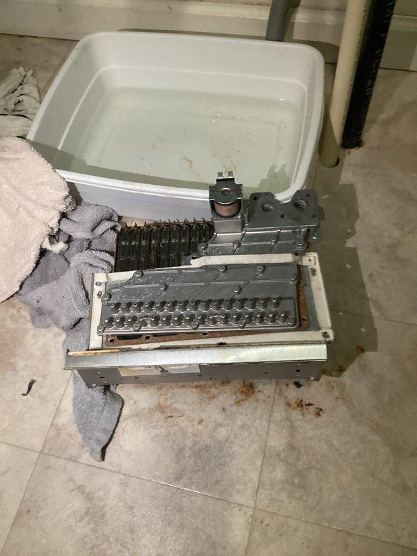 Performed diagnostic assessment on tankless water heater with existing manufacturer warranty. Disassembled unit to inspect heat exchanger components, which showed signs of failure. Documented condition of internal components including copper piping, wiring, and valves for warranty replacement process. Customer has been informed about warranty coverage for complete replacement through our company.
