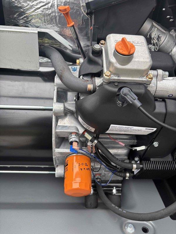 Performed scheduled generator tune-up service on a Honeywell unit with warranty through 06/2027. Conducted comprehensive inspection of engine components including fuel lines, oil filter system, and electrical connections. Verified proper operation of control panel and warning systems, confirming unit is correctly installed on appropriate gravel base with adequate ventilation.