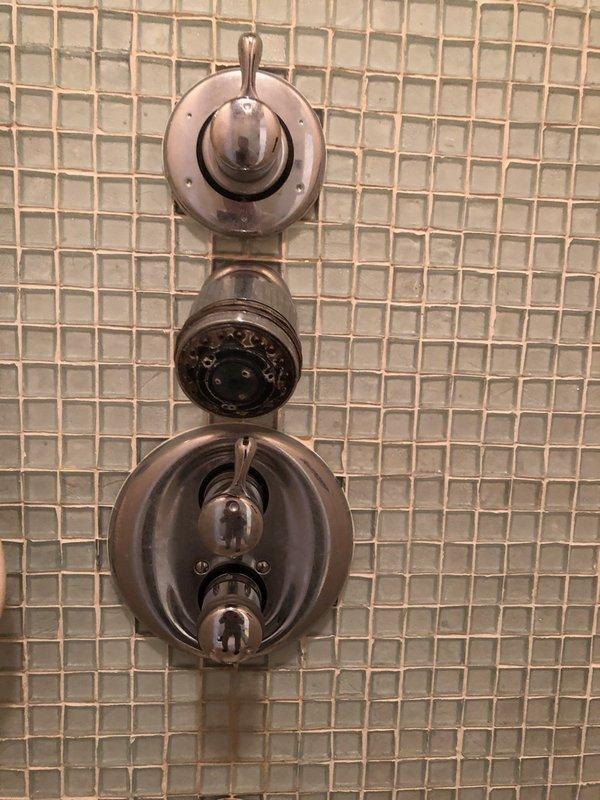 Serviced Kohler temperature control valve in master bathroom shower system featuring multiple shower heads. Diagnosed and repaired non-functioning temperature adjustment mechanism that was allowing only hot water flow. System now provides proper temperature regulation across all four shower heads.