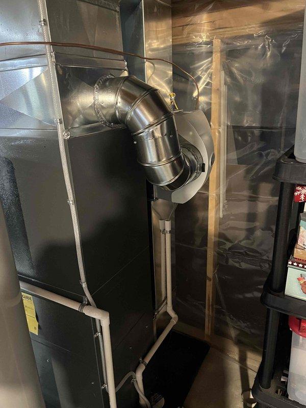 Completed installation of new furnace and AC system. Installed outdoor condenser unit on concrete pad with proper electrical connections. Mounted indoor furnace unit with professional ductwork including 90-degree bend and PVC piping for condensate drainage.