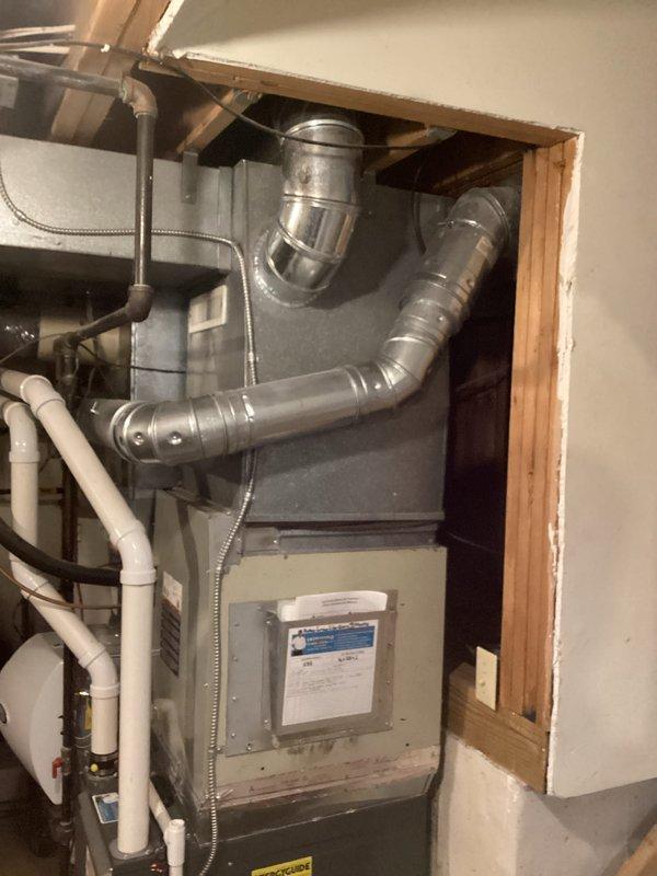 Completed assessment for replacement of 30-year-old propane-fueled tank water heater for family of 6 with two full bathrooms in 30-year-old home. Documented existing Lochinvar water heater installation with associated plumbing connections and ventilation system. Took photos of current setup including the water heater and adjacent HVAC system to facilitate proper sizing and installation requirements for the replacement unit.