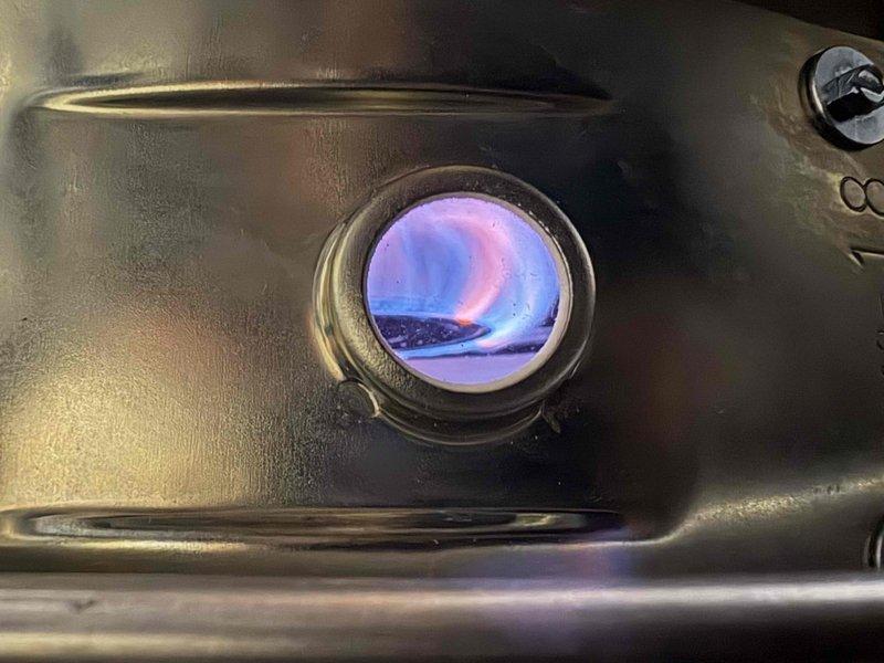 Successfully installed a 50-gallon natural gas power vent water heater with a 6-year warranty. Performed operational testing to verify proper ignition sequence and confirmed healthy blue flame pattern with expected pink/purple hues through inspection port, indicating complete combustion and optimal burner performance.