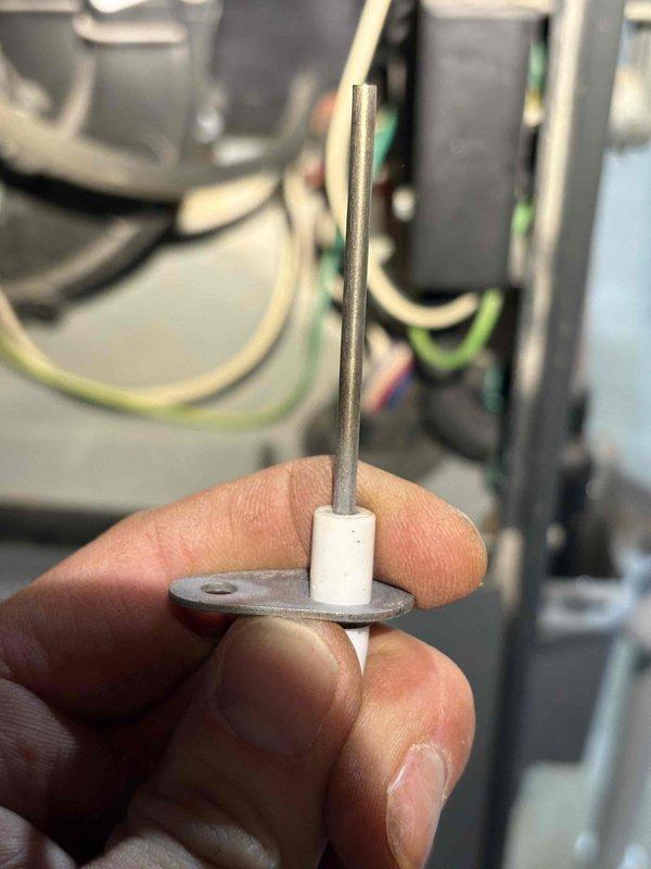 Responded to water leak concern near a 13-year-old Goodman furnace. Inspected system and identified deteriorated electrode/flame sensor with visible cracking, which was causing water intrusion during heavy rainfall. Replaced damaged component and secured proper mounting to prevent future leakage.