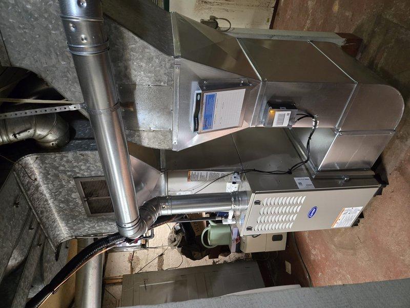 Successfully completed installation of new furnace and air conditioning system. Installed furnace unit with proper ductwork connections in utility area and mounted AC condenser unit on concrete pad with Puron Advance refrigerant lines connected to the home. All components professionally installed with appropriate electrical connections and verified operational.