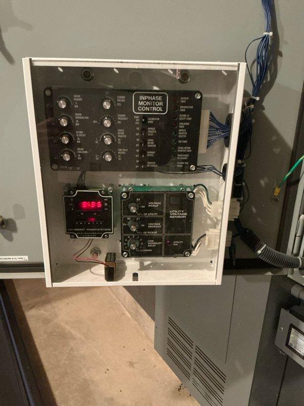 Completed replacement estimate for 20-year-old furnace and AC system in single-family residence. Documented existing electrical control panel featuring InPhase Monitor Control system with utility monitoring capabilities. Inspected basement mechanical room housing aging furnace with exposed control wiring and ventilation components, noting proximity to Generac backup power system.