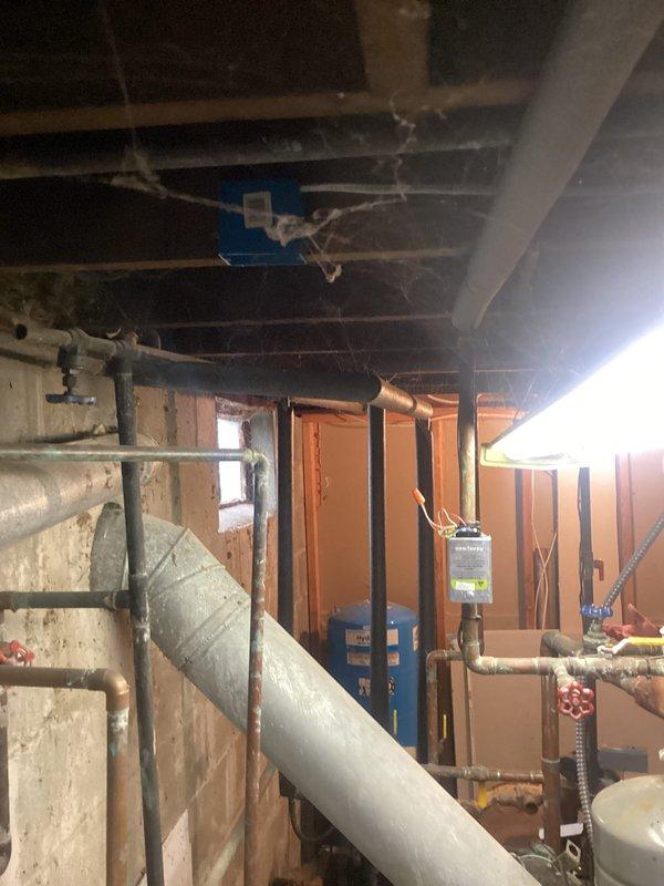 Conducted comprehensive site assessment for potential replacement of aging mechanical systems including 25+ year old boiler (requiring annual repairs for past 5-6 years), 10-year-old water heater, and 22+ year-old water softener. Evaluated existing plumbing configuration, documenting disorganized pipe layout requiring complete rework. Provided customer with detailed estimate options for: 1) combi boiler system, 2) tankless boiler with separate tankless water heater, and 3) water softener replacement with complete replumbing of mechanical area.