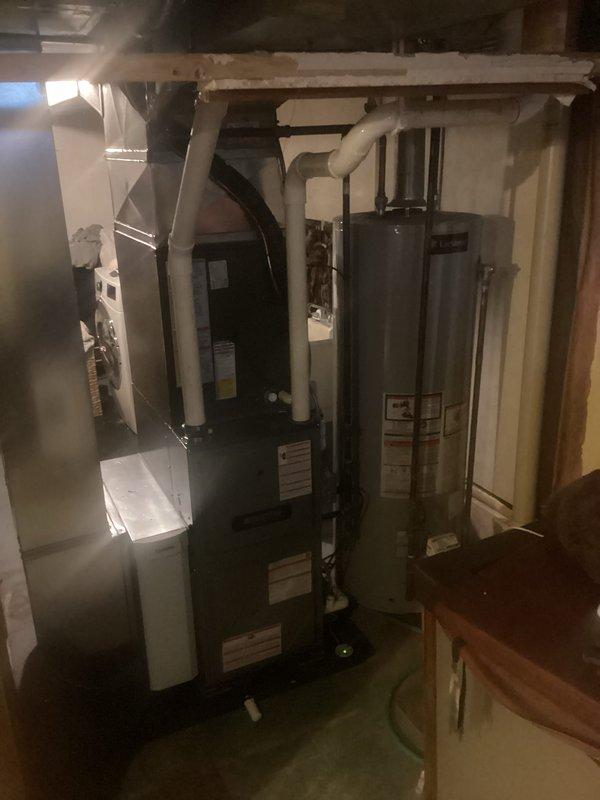 Completed installation of new furnace and air conditioning system in basement utility area. System was properly connected to existing ductwork and plumbing infrastructure with all necessary venting installed. Final inspection confirmed proper operation of both heating and cooling components.