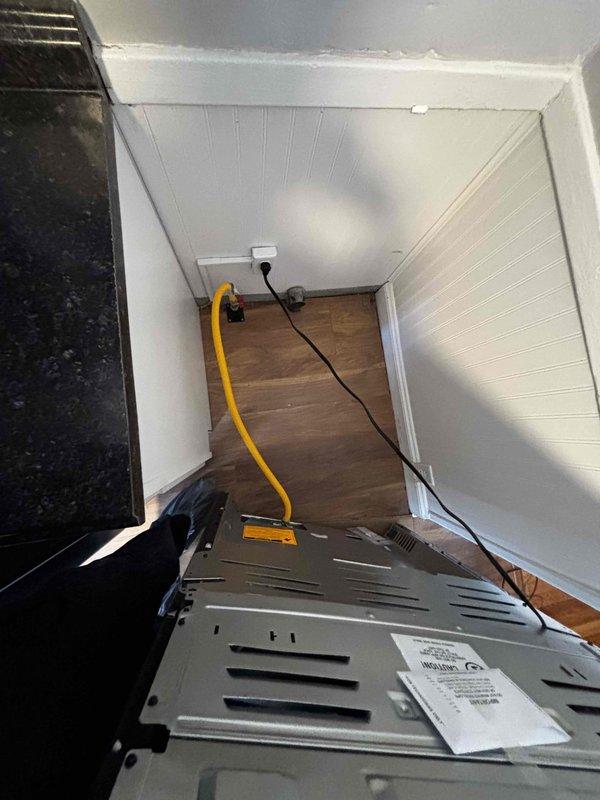 Performed gas line inspection and assessment at property accessed via rear entrance (code 0657). Evaluated existing CSST yellow gas line installation and connection to valve fitting in corner area with beadboard paneling. Documented current setup with photos and provided detailed repair estimate for minor gas line modifications needed for safe appliance operation.