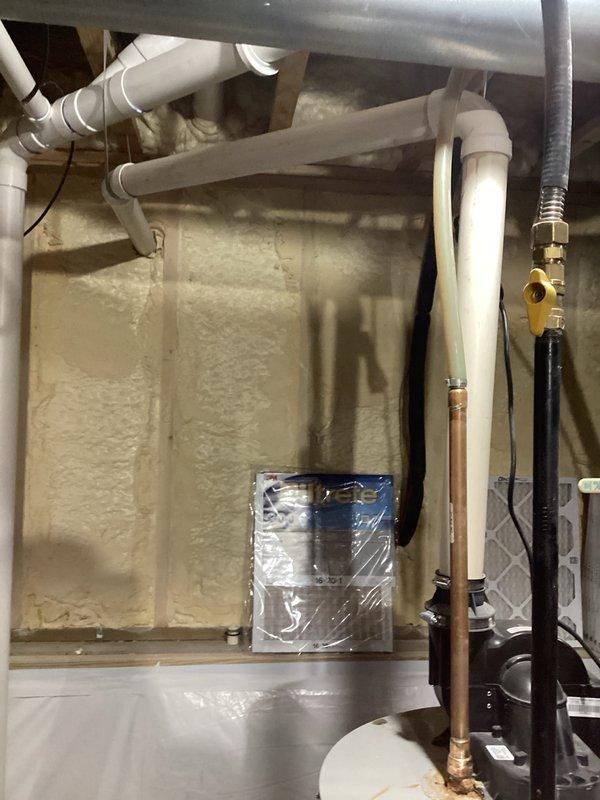 Conducted estimate for leaking water heater that is not producing hot water. Existing unit is a cylindrical metallic water heater with copper pipes connected to top section, installed in basement utility area. Inspected associated plumbing infrastructure including PVC piping, brass valves, and connections to determine replacement requirements.