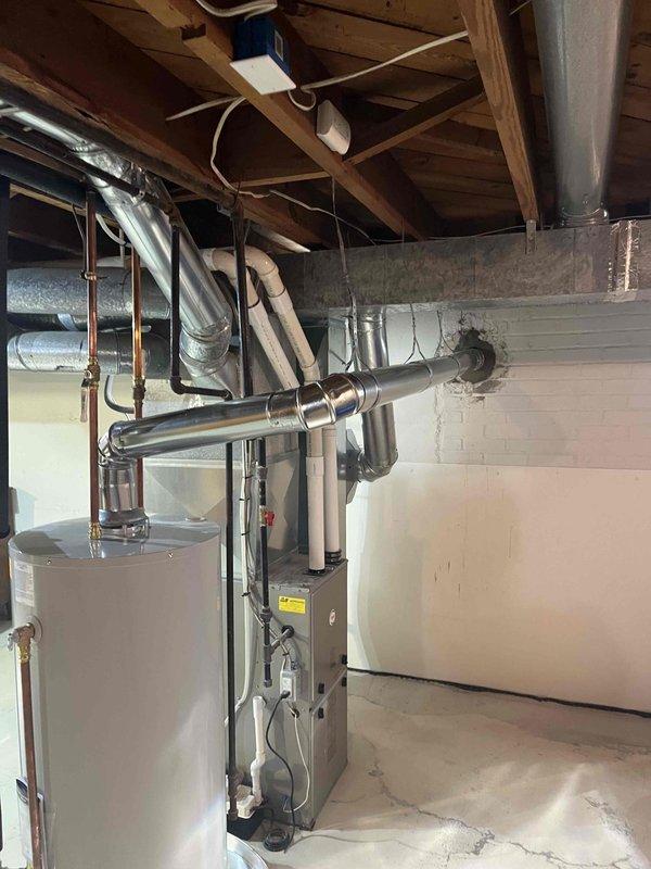 Completed correction on ventilation system per inspector's requirements. Modified single wall vent connection at mortar sleeve, ensuring proper crimping and installation of vent pipe directly to Z-flex liner per manufacturer specifications. Documented completed work with photos showing proper venting through concrete block wall.