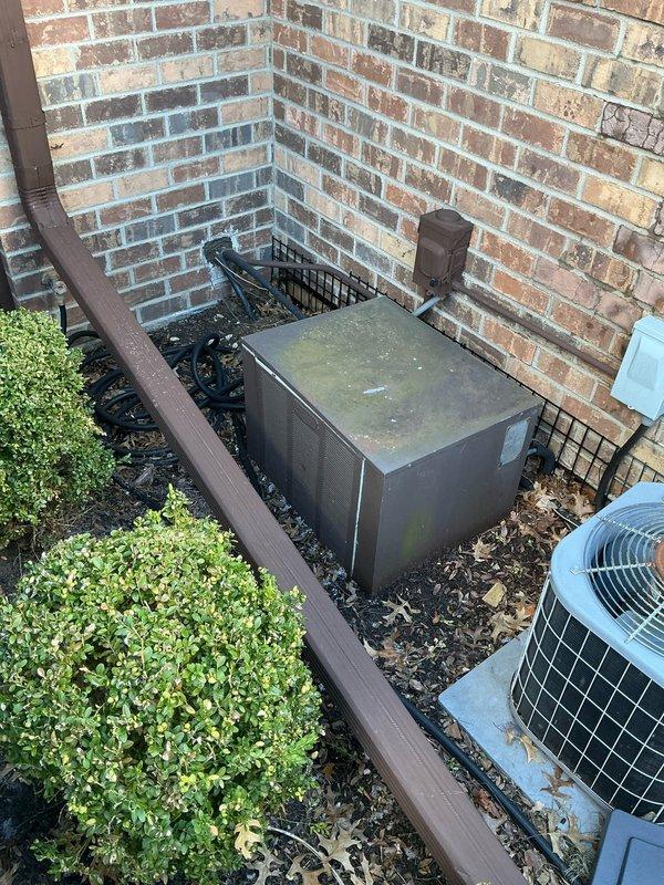 Conducted comprehensive assessment for new air conditioning system installation at side-by-side condo property. Inspected existing outdoor unit location (currently enclosed in protective cage adjacent to brick exterior wall) and evaluated interior Carrier furnace system with connected ductwork in utility room. Documented current system configuration with photographs to facilitate accurate equipment sizing and installation planning for replacement AC system.