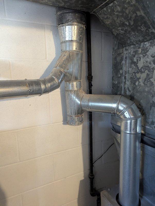 Diagnosed knocking noise in 4-year-old water heater (CM: 2025) by inspecting ductwork and plumbing connections. Determined noise was caused by thermal expansion in the metal vent pipe during heating cycles; confirmed normal operation with no leaks or functionality issues present.