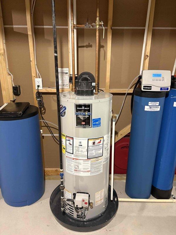 Diagnosed Defender water heater with flashing green light (4 blinks) indicating error code. Reset thermal switch to restore hot water functionality after verifying proper electrical connections and water supply. Recommended monitoring system performance as this is a recurring issue that previously occurred 3-4 weeks ago on this 3-year-old unit.