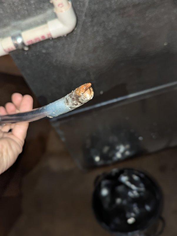 Responded to water leak issue with 21-year-old Aprilaire humidifier. Inspection revealed severely corroded water supply pipe with significant rust damage, causing the reported leak. Documented condition with photos showing deteriorated filter assembly and damaged supply line.