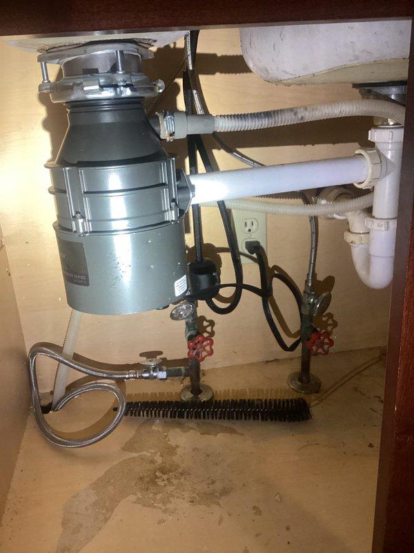 Responded to service call for a detached garbage disposal and compromised sink drain. Diagnosed failure in mounting assembly and drain pipe connection. Successfully reinstalled garbage disposal unit with new hardware, reconnected all plumbing components, and verified proper operation of both disposal and left sink basin drainage.