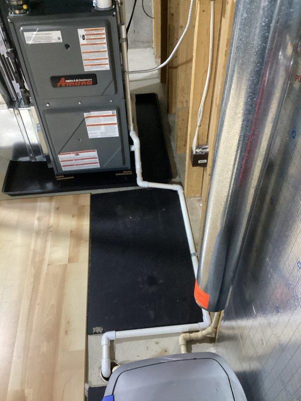 Successfully completed installation of new Amana furnace and AC system, including proper mounting of furnace on platform with connected PVC venting and drainage. System includes all necessary ductwork connections and was fully tested to ensure optimal performance.