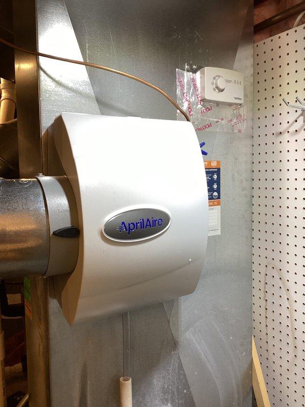 Performed annual heating maintenance on 13-year-old Carrier furnace. Inspected and cleaned AprilAire humidifier unit mounted on HVAC system. Checked water supply connections, including copper and PVC plumbing components, and verified proper operation of humidifier as part of service club maintenance.
