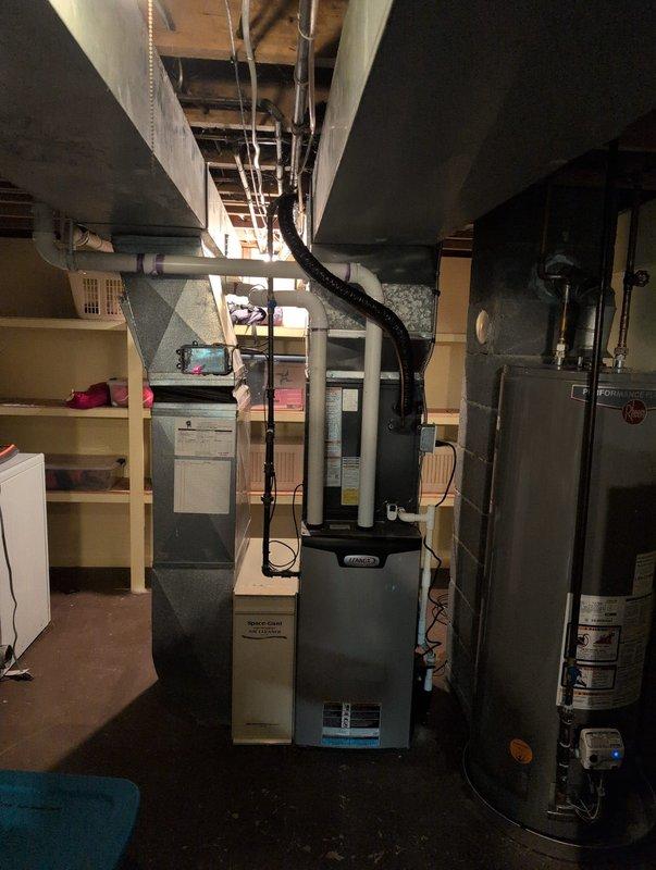 Successfully installed a new air conditioning system with Michigan Saves financing. The installation included proper mounting of the outdoor condenser unit on a concrete pad with appropriate electrical connections and PVC line set. System was integrated with the existing furnace and ductwork in the utility room, with all components properly connected and operational.