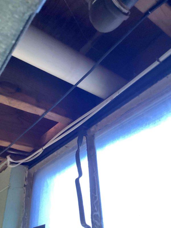 Assessed customer's existing gas water heater for potential replacement. Inspected installation location in basement utility area, noting current unit's connection to gas line and venting system through ceiling. Documented surrounding infrastructure including HVAC system and available space for new unit installation.