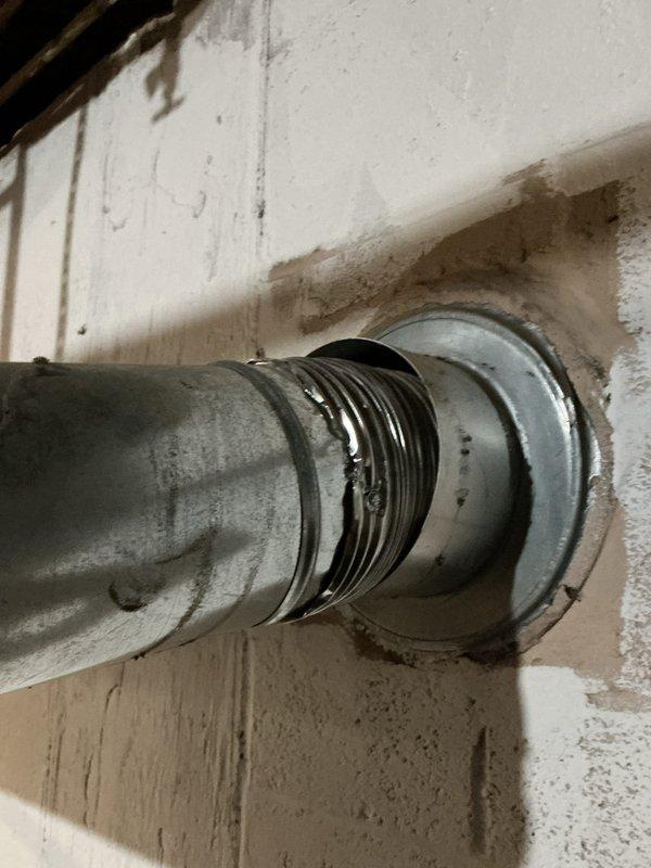 Responded to no hot water complaint on 13-year-old Bradford White water heater. Inspected unit and ventilation system, focusing on the vent pipe connection through the wall which showed signs of wear and improper sealing. Repaired flue connection and restored hot water functionality to the system.