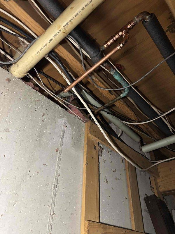 Completed replacement of reverse osmosis filtration system including new storage tank and bar sink faucet in kitchen. Installed three new shut-off valves in cabinet, replaced leaking drain line section connected to toilet and shower branch with new eye trap and piping, and repaired leaking water pipe section above well tank with new piping and spigot.