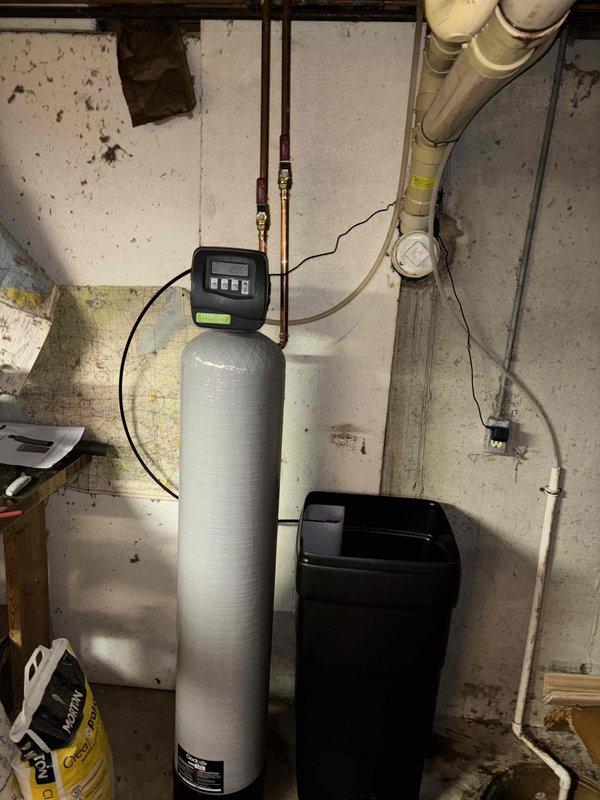 Completed replacement of reverse osmosis filtration system including new storage tank and bar sink faucet in kitchen. Installed three new shut-off valves in cabinet, replaced leaking drain line section connected to toilet and shower branch with new eye trap and piping, and repaired leaking water pipe section above well tank with new piping and spigot.