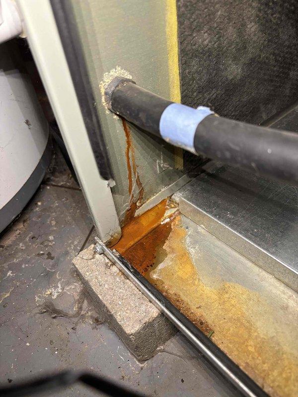Performed annual heating maintenance on customer's furnace. Identified significant rust and corrosion at the base of the unit with evidence of an active water leak where the condensate line connects to the cabinet. Documented the deterioration with photos for customer records and recommended professional repair of the leaking connection to prevent further damage.