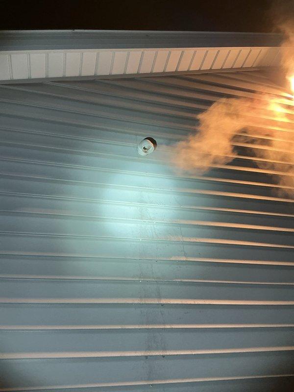 Responded to no-heat call and identified vapor/smoke discharge from ceiling vent system. Inspection revealed improper PVC pipe elbow connection in the ventilation system causing exhaust gases to escape into the living space. Repaired the disconnected vent pipe and secured all joints to restore proper exhaust flow, resolving the heating safety issue.