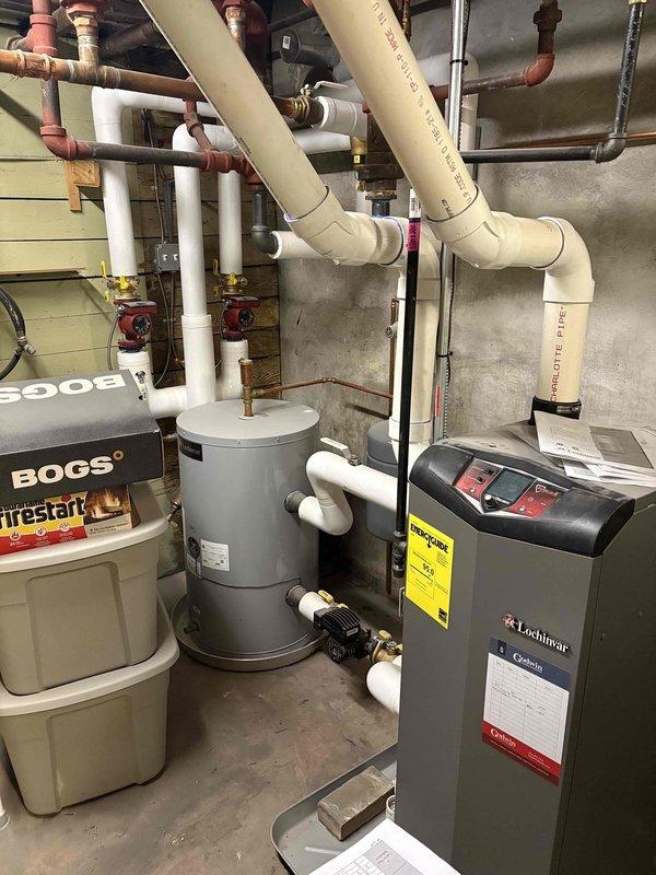 Responded to emergency no-heat call, diagnosed Lochinvar boiler system which was operational but not delivering heat. Inspected Smart System control panel showing normal temperature readings (system at 88°F/143°F, tank at 120°F/120°F, outdoor at 43°F) and verified all components were functioning correctly. Determined issue was with thermostat communication to boiler; reprogrammed thermostat settings to restore proper heat delivery to residence.