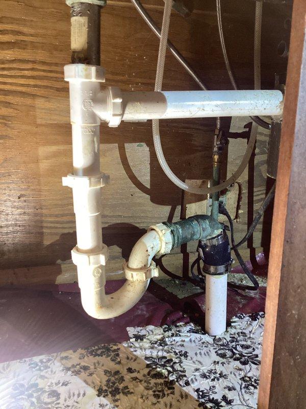 Cleared kitchen sink drain blockage by disassembling and cleaning the P-trap assembly. Identified significant corrosion on copper drain lines in basement with green oxidation at joints, suggesting potential future issues. Restored proper drainage functionality and advised customer about the aging plumbing system.