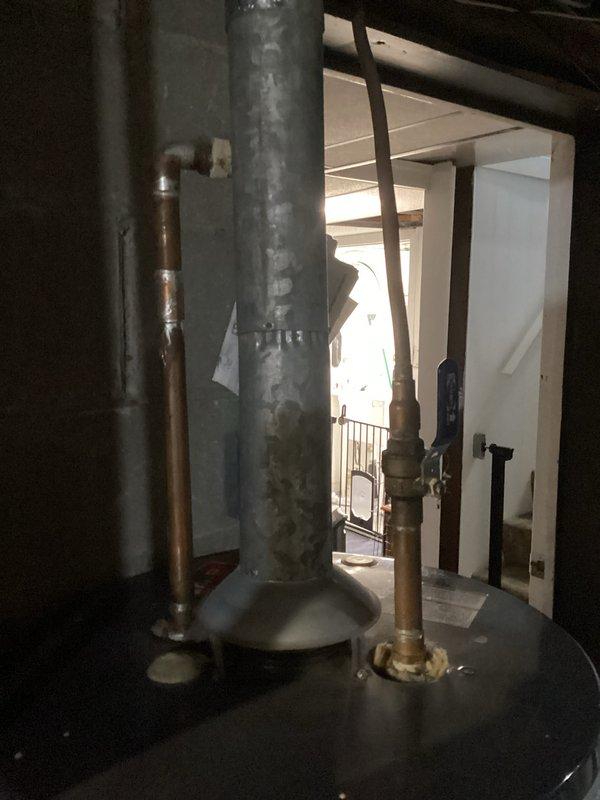Performed scheduled water heater tune-up on a 20-year-old American brand unit. Inspected all connections, checked venting system functionality, and verified proper operation of temperature and pressure relief valve. Unit shows normal signs of aging on copper piping and fittings but remains in functional condition with no immediate safety concerns identified.