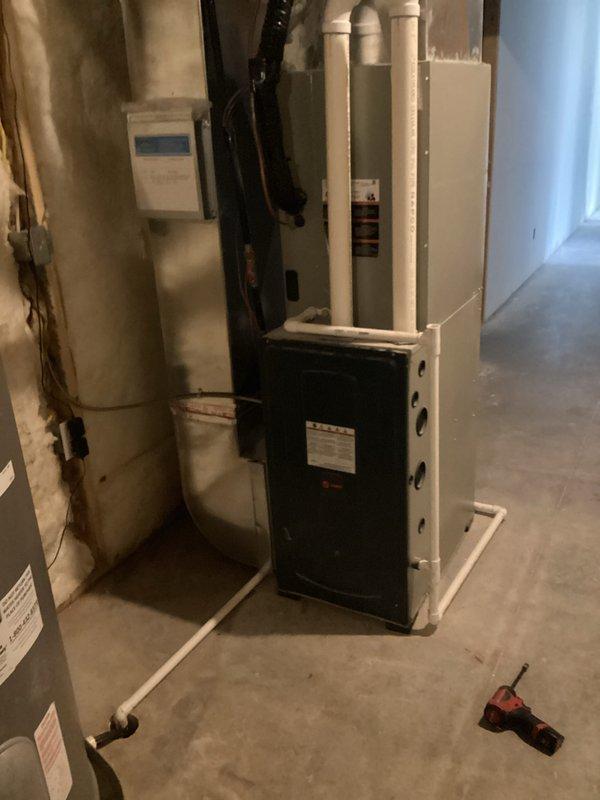 Performed annual tune-up on 3-year-old Trane furnace system as part of complimentary maintenance service. Inspected water heater and existing HVAC equipment in basement mechanical room. Discussed customer's interest in natural gas conversion options for furnace, stove, and fireplace.