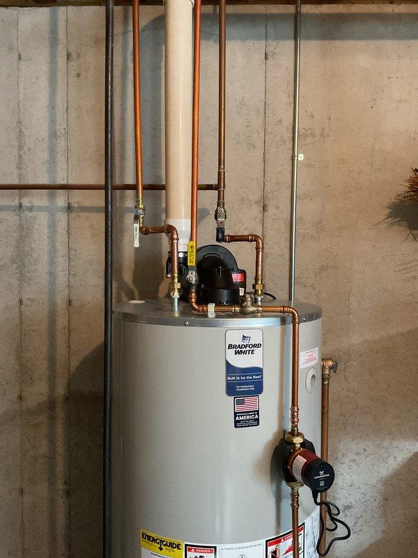 Successfully installed a Bradford White 75-gallon natural gas water heater with power vent and 10-year warranty. Completed all necessary copper and PVC piping connections, installed circulation pump on top of the tank, and verified proper function of the pressure relief valve. System was tested and confirmed to be operating correctly with no leaks.