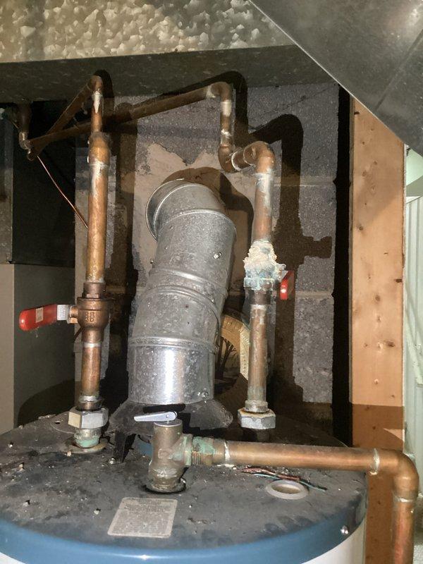 Responded to emergency call for leaking Richmond water heater approximately 5 years old. Inspection revealed significant corrosion at dissimilar metal connection points between copper piping and galvanized steel components. Replaced deteriorated dielectric unions, installed new pressure relief valve, and performed comprehensive system test to verify proper operation and absence of leaks.