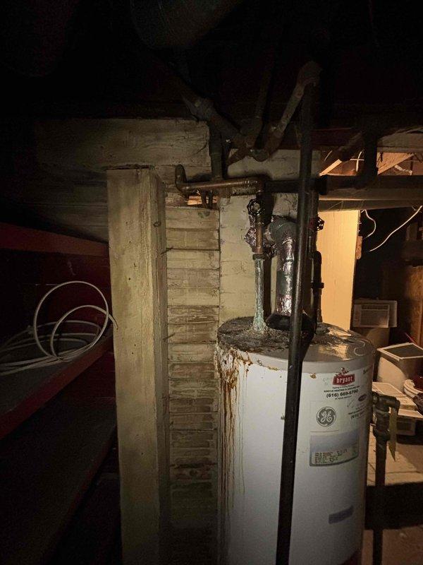 Inspected 5-year-old GE water heater showing significant corrosion and rust staining from top connections down the tank. Used borescope camera to examine internal components and identified deterioration requiring attention. Completed necessary repairs to address leakage issues while maintaining unit's heating functionality.