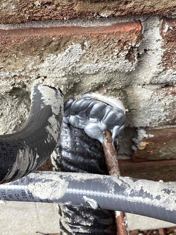 Inspected furnace installation where client reported excessive drafts from piping and venting system. Observed deteriorated insulation on refrigerant lines with exposed foam material at several connection points. Sealed compromised pipe junctions with appropriate metallic wrap and repositioned insulation to minimize air infiltration through wall penetrations.