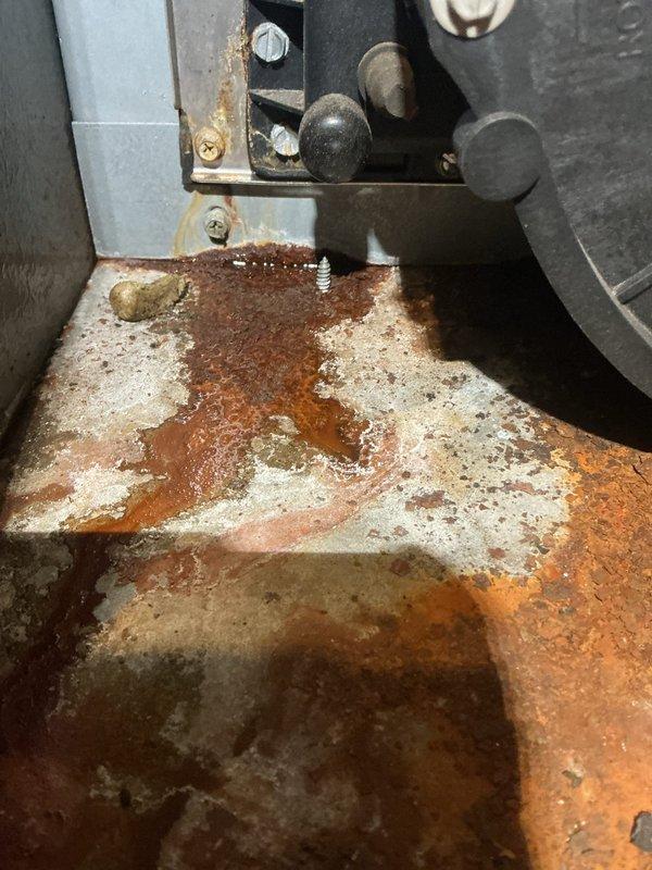 Performed annual heating maintenance on 15-year-old Goodman furnace. Documented significant rust and corrosion on heat exchanger and base plate with evidence of moisture accumulation. Recommended replacement due to safety concerns as unit is beyond expected service life.