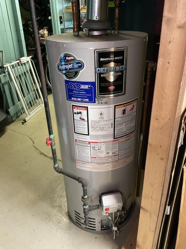 Responded to service call for 13-year-old Bradford White water heater not producing hot water. Diagnosed and relit extinguished pilot light, verified proper operation of gas valve and thermocouple. System now functioning correctly with consistent flame pattern and adequate hot water production.