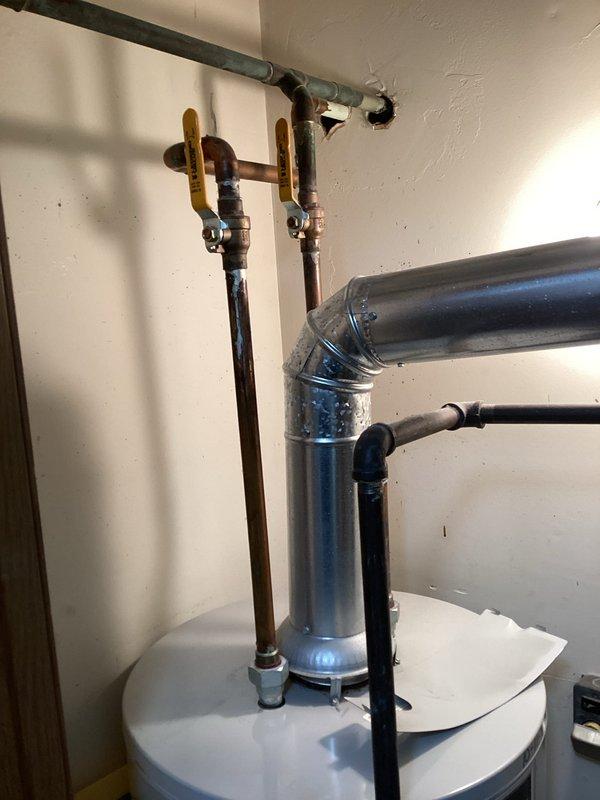 Responded to service call for 11-year-old Bradford White water heater with pilot light issue. Upon inspection, relit pilot light and verified proper operation of water heater. System is now functioning correctly with no additional issues observed in the installation, which includes proper venting and connection of supply lines.