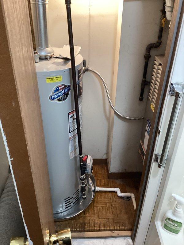 Responded to service call for 11-year-old Bradford White water heater with pilot light issue. Upon inspection, relit pilot light and verified proper operation of water heater. System is now functioning correctly with no additional issues observed in the installation, which includes proper venting and connection of supply lines.