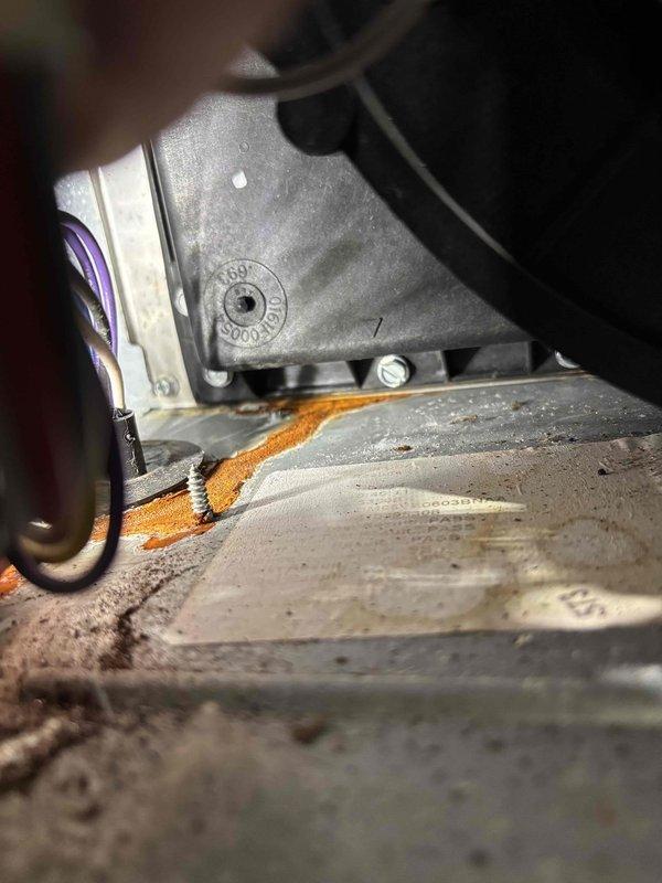 Diagnosed water leak on 11-year-old Daikin furnace system; inspection revealed severe corrosion and rust on copper pipe elbow fitting causing water to leak onto mounting panel. Documentation with photos shows extensive rust damage and moisture accumulation in the equipment housing.