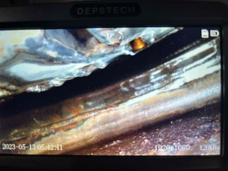 Responded to service call for 11-year-old Lochinvar boiler making wooshing noise. Performed inspection using endoscope camera to examine internal components, revealing corrosion and deterioration in copper piping. Diagnostic testing identified system in lockout mode with "FLAME FAIL RUNNING" error displayed on Knight control panel, indicating combustion issues affecting proper operation.